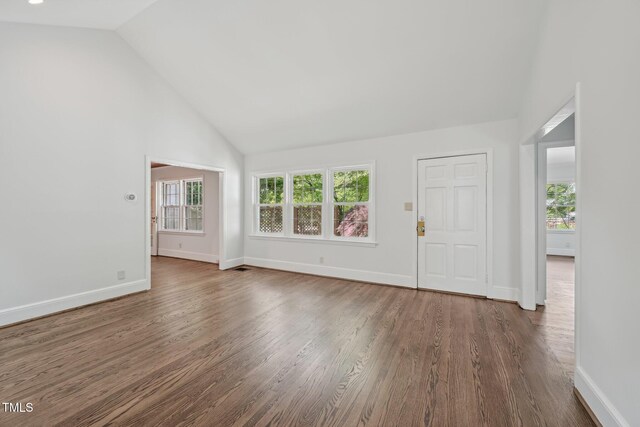 1316 Glenwood Ave, Raleigh, NC 27605 - unfurnished living room featuring baseboards, plenty of natural light, and wood finished floors