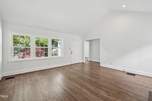 1316 Glenwood Ave, Raleigh, NC 27605 - unfurnished living room featuring baseboards, visible vents, and vaulted ceiling