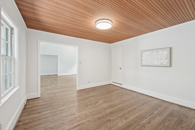 1316 Glenwood Ave, Raleigh, NC 27605 - unfurnished room with crown molding, baseboards, wooden ceiling, and wood finished floors