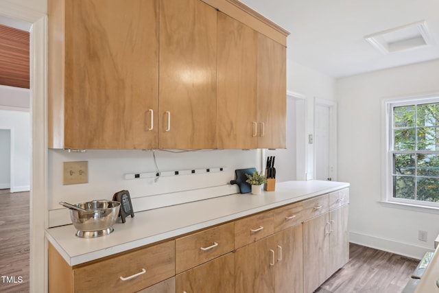 1316 Glenwood Ave, Raleigh, NC 27605 - kitchen featuring light countertops, baseboards, visible vents, and wood finished floors