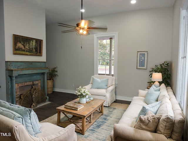 living room featuring ceiling fan and dark hardwood / wood-style flooring