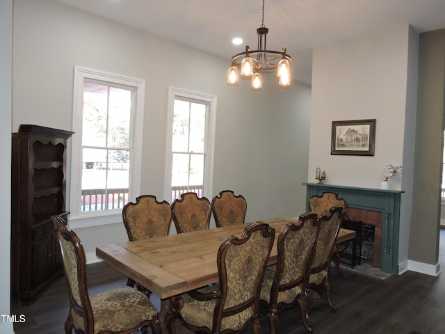 dining area featuring dark hardwood / wood-style floors and a chandelier