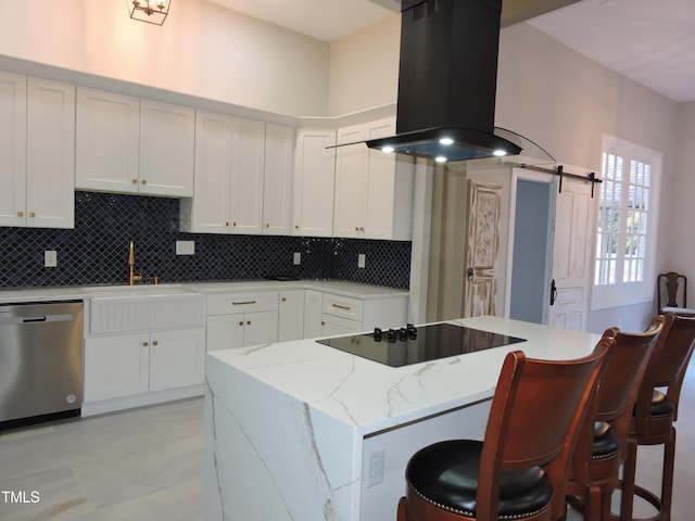 kitchen featuring island range hood, black electric stovetop, white cabinetry, a barn door, and stainless steel dishwasher