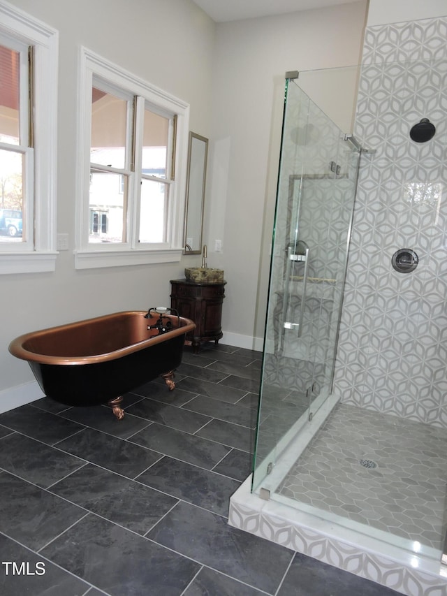 bathroom with plus walk in shower, tile patterned floors, and a healthy amount of sunlight