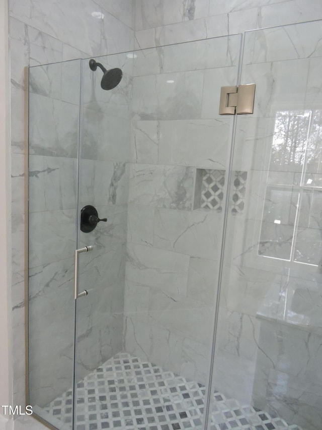 bathroom featuring a shower with door