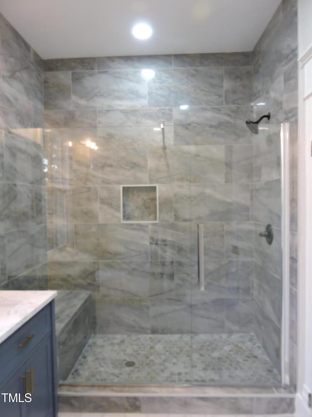 bathroom with walk in shower and vanity