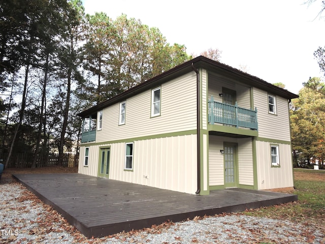 back of house with a balcony and a deck