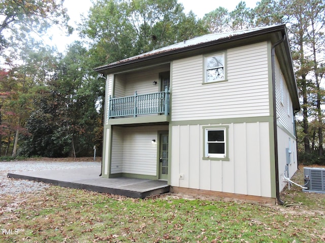 back of house with a balcony and central AC