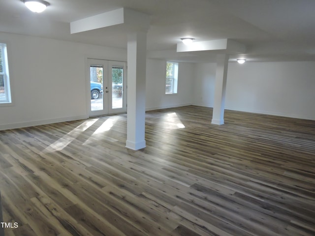 basement featuring french doors and dark hardwood / wood-style floors