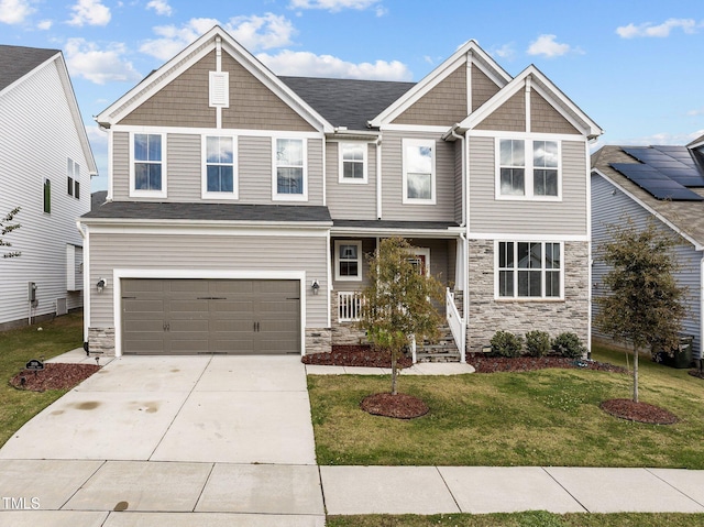 craftsman-style home with a front lawn and a garage