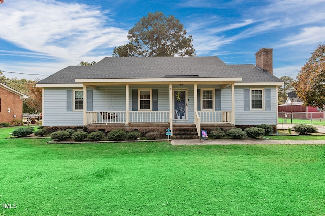 ranch-style home featuring a porch and a front yard