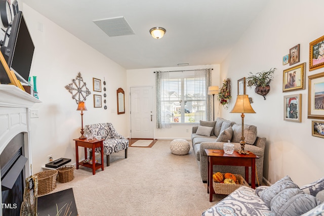 carpeted living room with visible vents, baseboards, and a fireplace with flush hearth