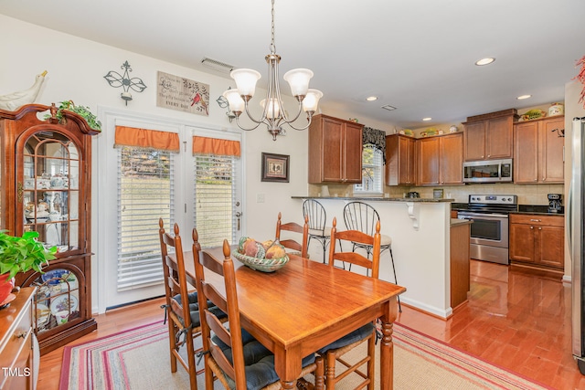 dining area featuring recessed lighting, a notable chandelier, light wood-style flooring, and visible vents