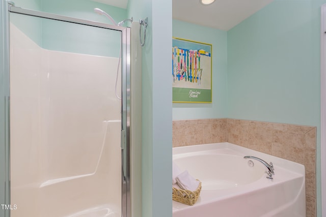 bathroom featuring a bath and a stall shower