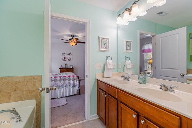 full bathroom featuring tile patterned floors, connected bathroom, double vanity, and a sink