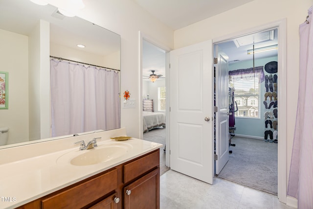 full bath with vanity, ensuite bath, and a ceiling fan