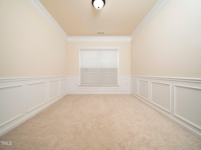 carpeted empty room featuring ornamental molding