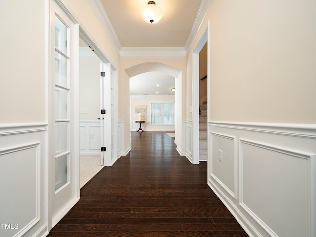 corridor with crown molding and dark wood-type flooring