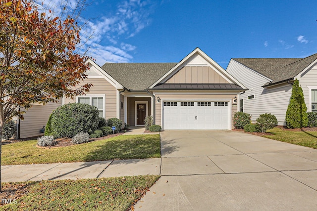 view of front of home with a garage and a front lawn