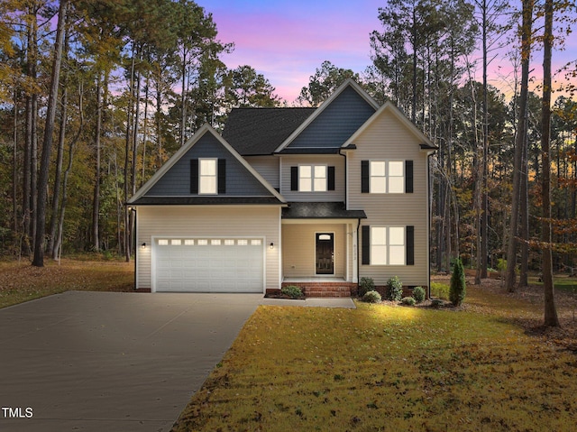 view of front facade with a lawn and a garage