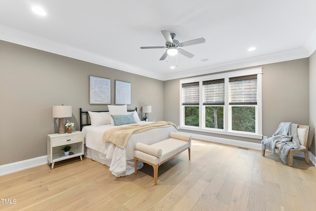 bedroom with light hardwood / wood-style floors, ceiling fan, and crown molding