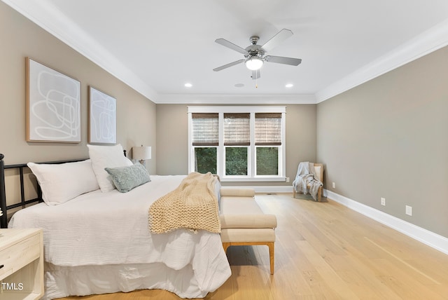 bedroom featuring ornamental molding, light wood-type flooring, and ceiling fan