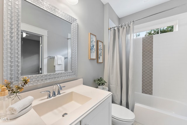 full bathroom featuring vanity, toilet, and shower / tub combo with curtain