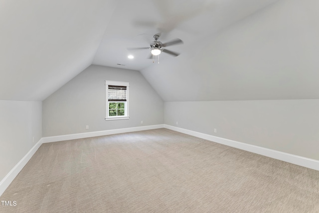 bonus room with ceiling fan, light carpet, and vaulted ceiling