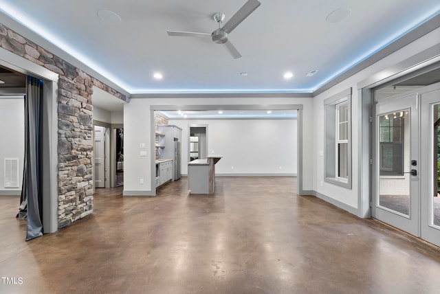 unfurnished living room featuring ceiling fan