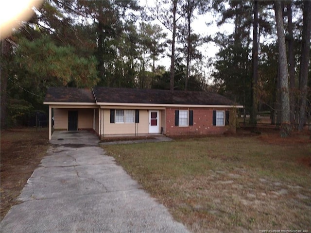 ranch-style house with a front lawn and a carport