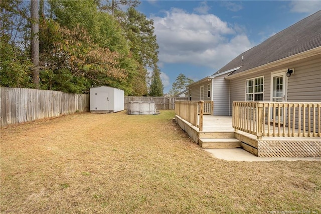 view of yard with a deck and a storage shed