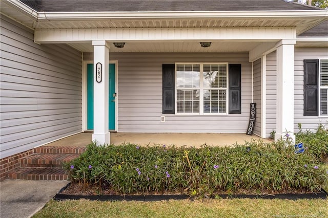 view of exterior entry with a porch