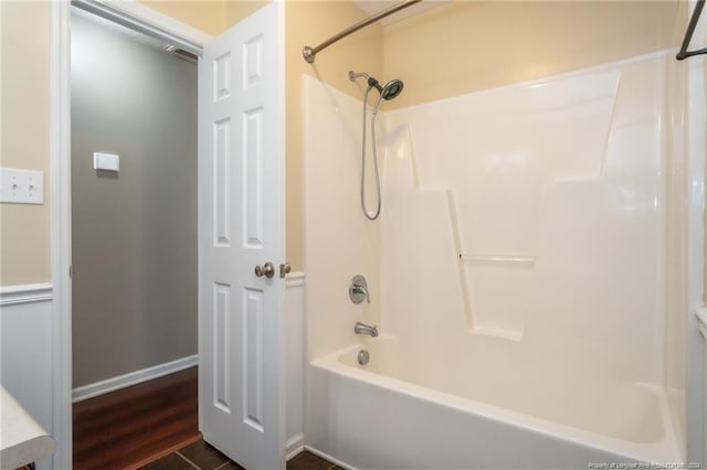 bathroom featuring hardwood / wood-style flooring and tub / shower combination