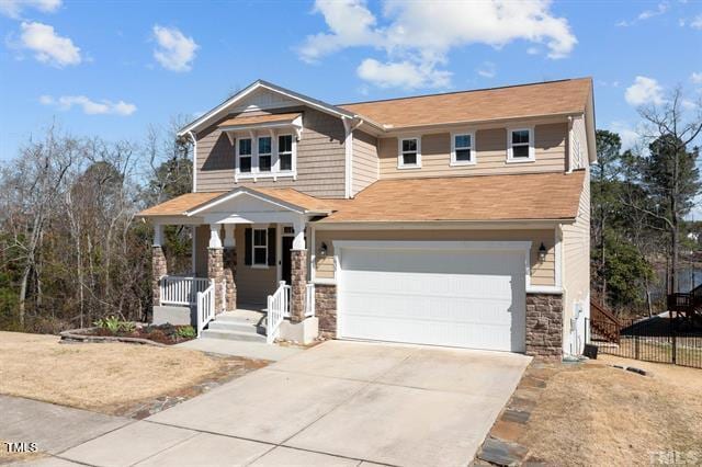 craftsman inspired home featuring covered porch and a garage