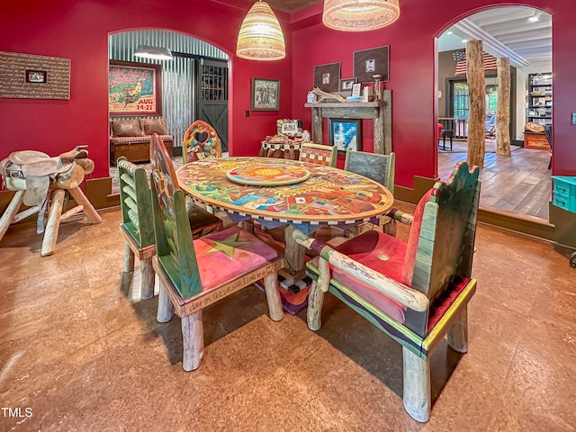 dining area featuring decorative columns and hardwood / wood-style flooring