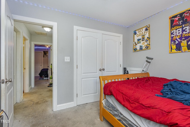 carpeted bedroom with a closet