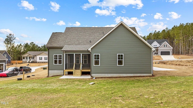 rear view of property featuring a lawn and a sunroom