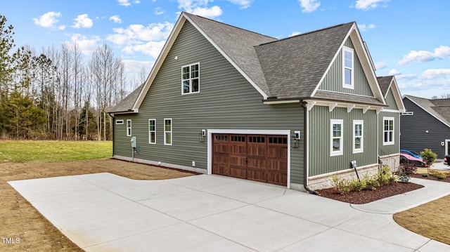 view of side of property with a garage and a yard