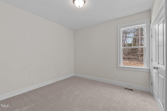 empty room featuring light colored carpet