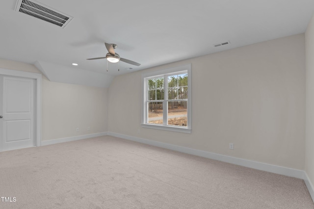 spare room with vaulted ceiling, ceiling fan, and carpet floors