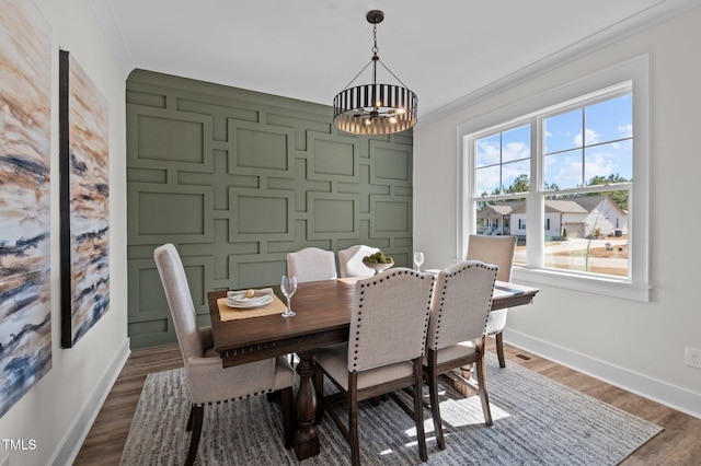 dining room featuring ornamental molding and dark wood-type flooring