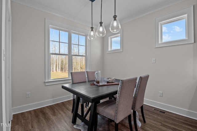 dining area featuring crown molding and dark hardwood / wood-style floors