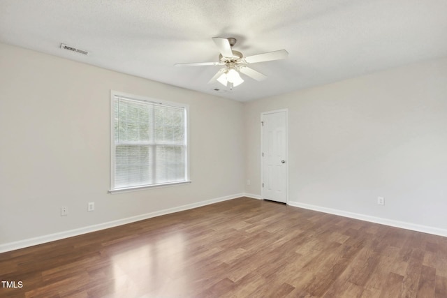 spare room featuring ceiling fan, a textured ceiling, and dark hardwood / wood-style flooring