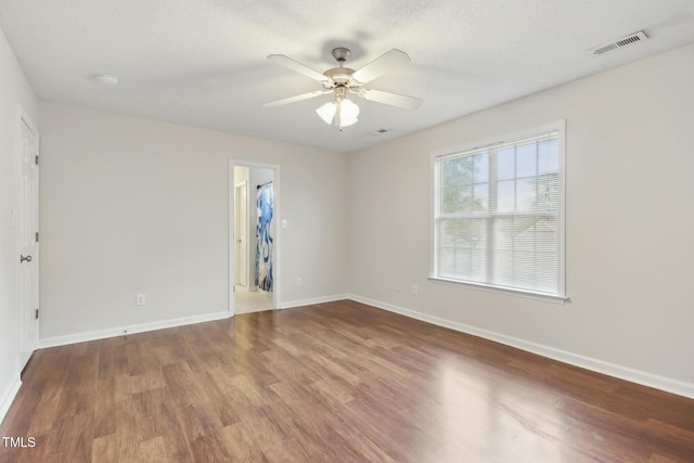 unfurnished room with hardwood / wood-style floors, ceiling fan, and a textured ceiling