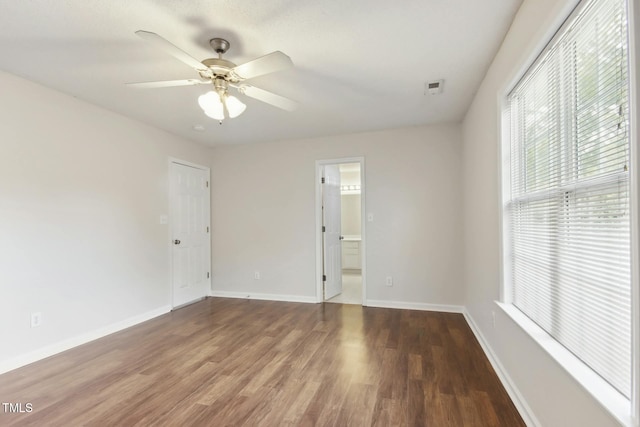 spare room featuring ceiling fan and dark hardwood / wood-style flooring