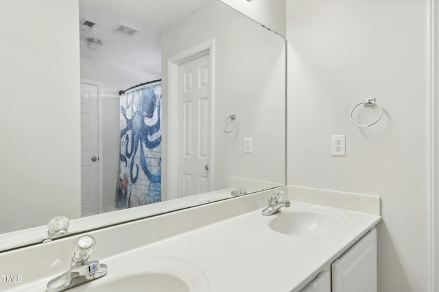 bathroom with vanity and curtained shower