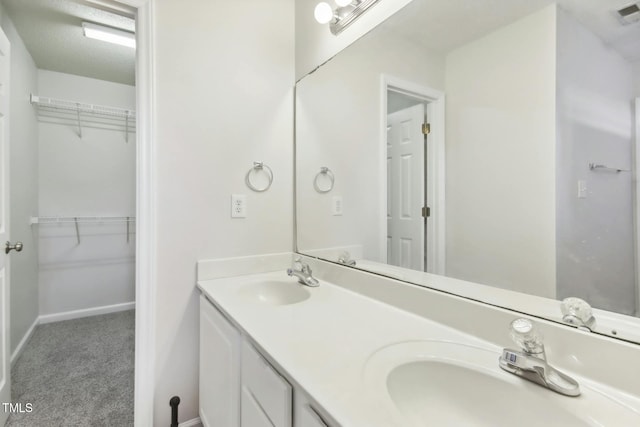 bathroom with vanity and a textured ceiling