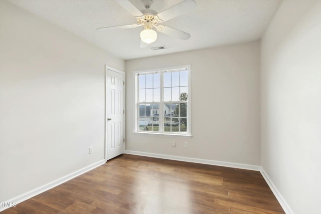 empty room featuring ceiling fan and dark hardwood / wood-style flooring