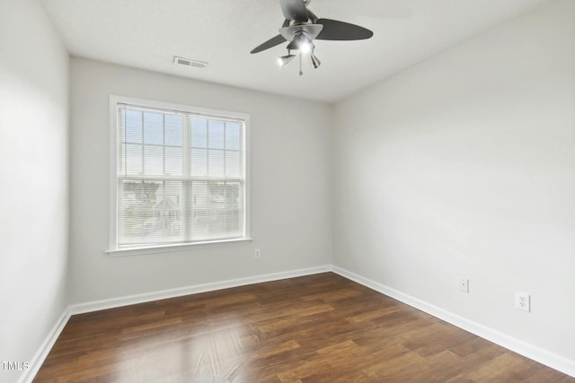 spare room with ceiling fan and dark hardwood / wood-style floors