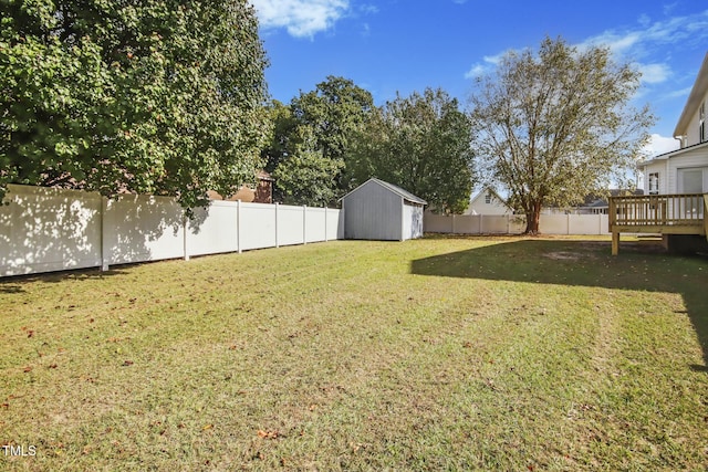 view of yard with a deck and a storage shed